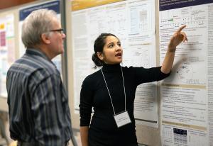 DCP&#039;s Dr. Matthew Young reviews a poster presentation by Aasthaa Bansal.