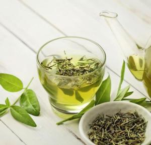 An image of green tea, brewed and leaves.