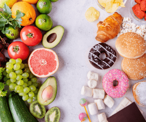 A collection of healthy foods on the left side of the image (e.g. fruits and vegetables) with unhealthy foods on the right side (e.g., donuts, chips, marshmallows)