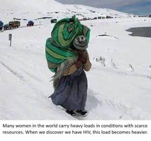 A woman carrying a heavy load while walking in snow