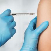 Image of needle injecting vaccine in arm.